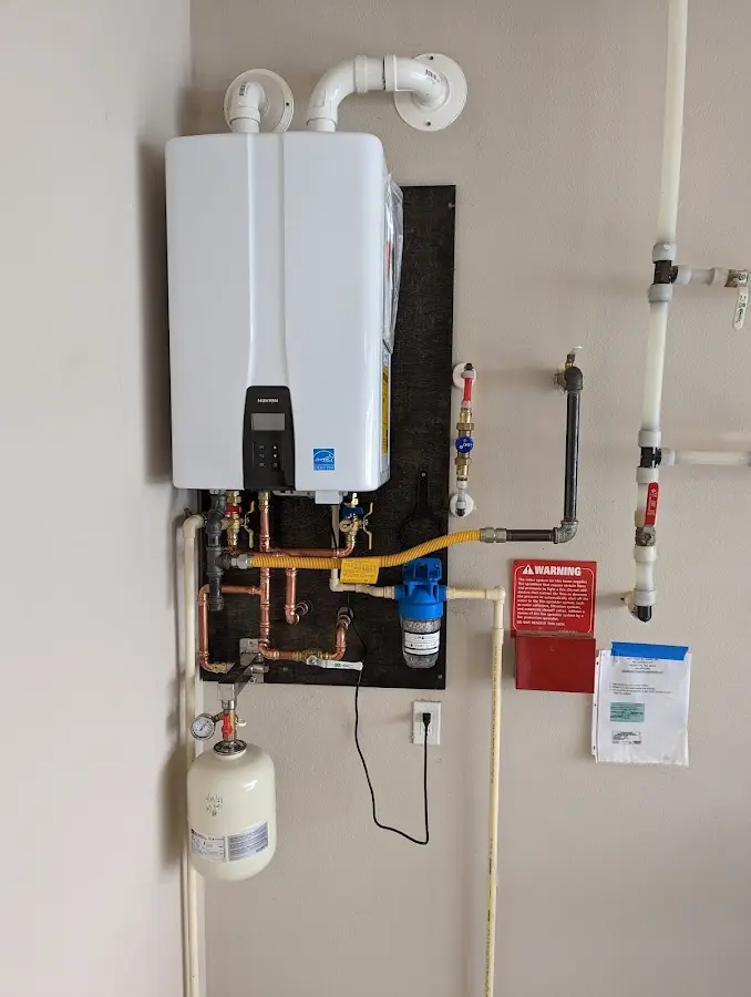 Professional plumber installing copper piping in a Forestbrook home